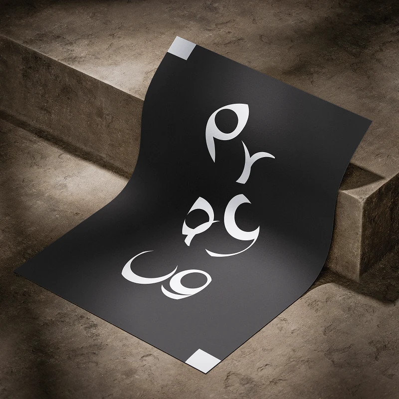 A black poster curling over a stone step, three white letterforms drawn from the Czech alphabet arranged down the sheet