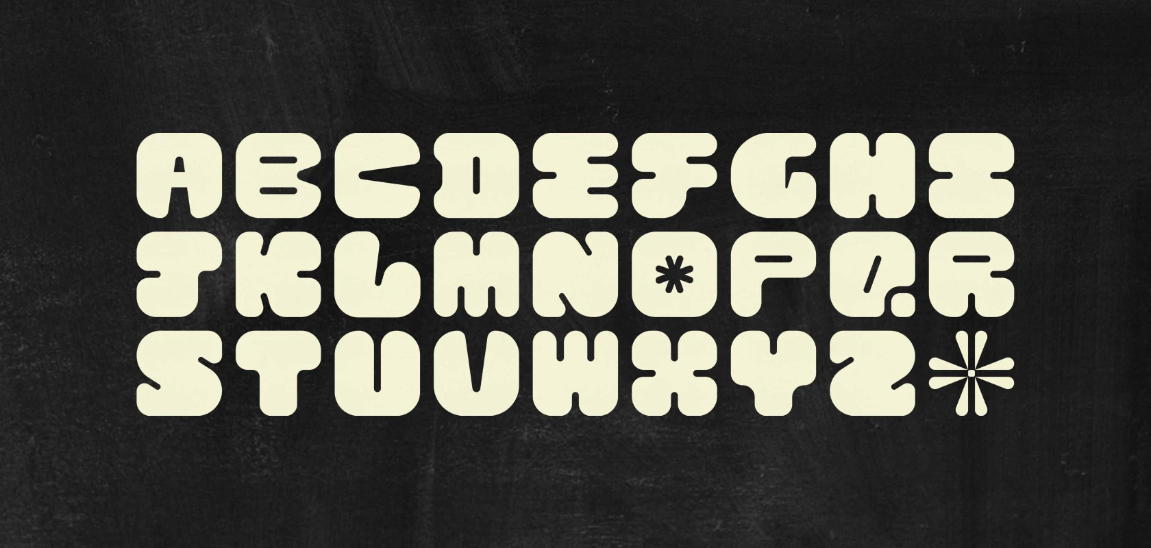 The full rounded alphabet in cream on black - fat, soft letters with almost no counters, and a flower-like asterisk